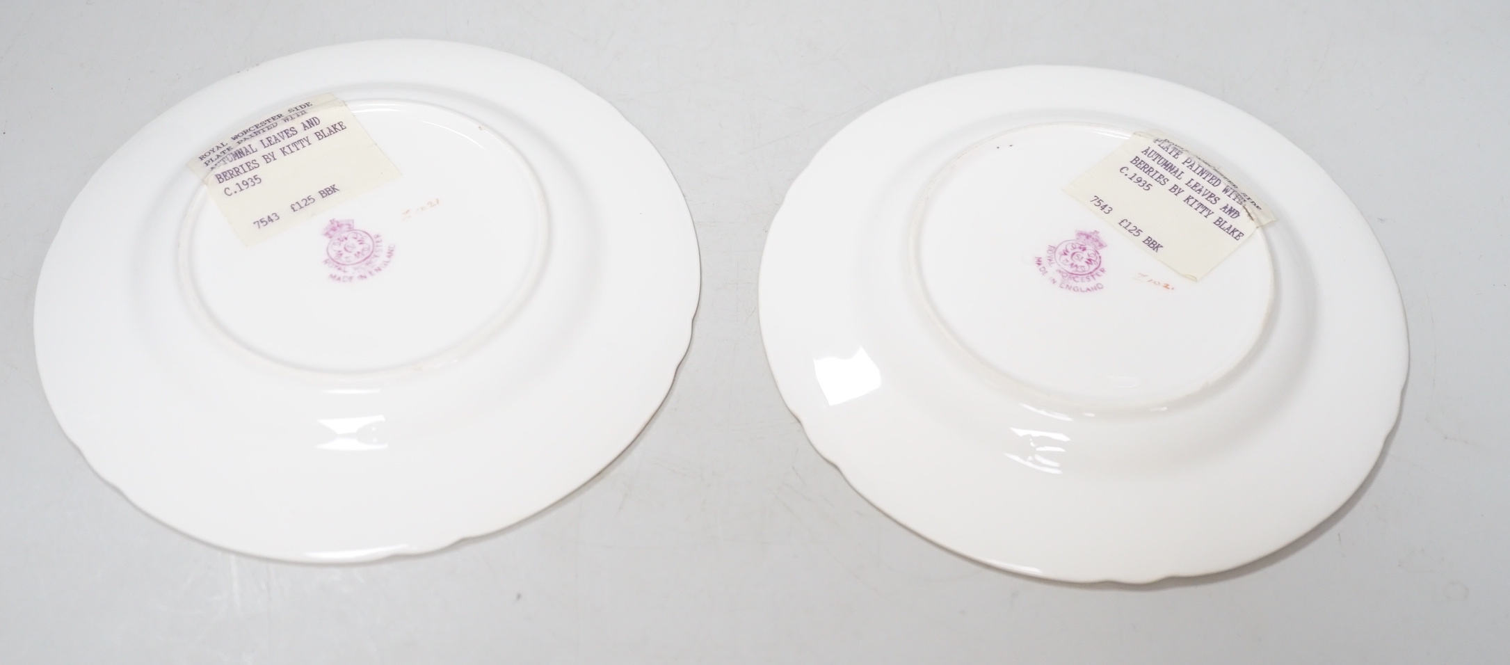 A pair of Royal Worcester lobed tea plates painted with autumnal leaves and berries by Kitty Blake, signed date mark 1935